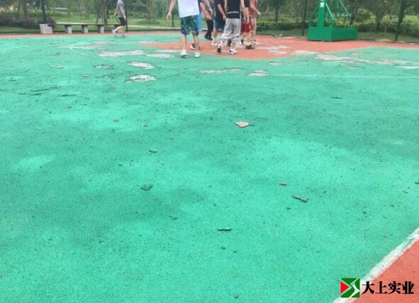 塑胶地面脱落的碎片散布在篮球场内